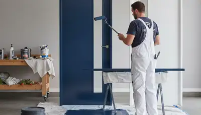 Professional painter refinishing front door in Tacoma, WA for durable, weather-resistant home exterior finish